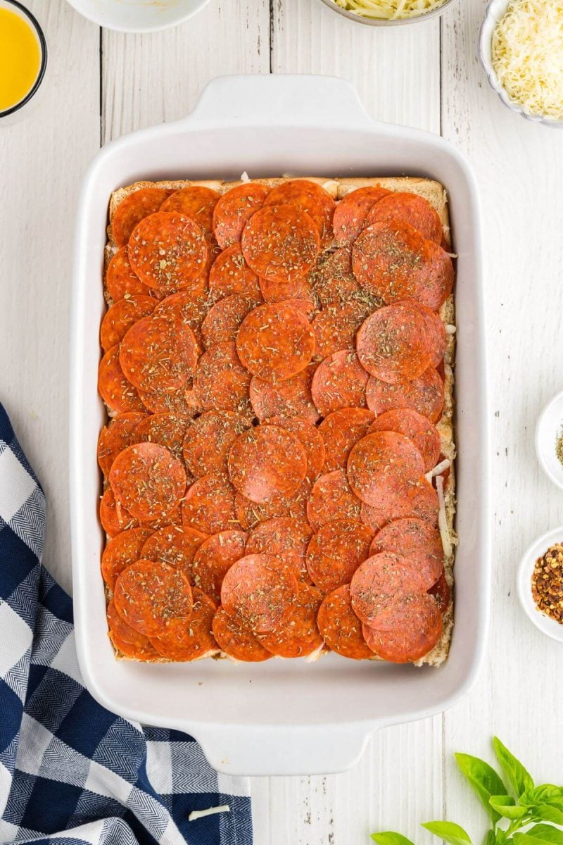 Layer on the pepperoni and sprinkle with Italian seasoning. 