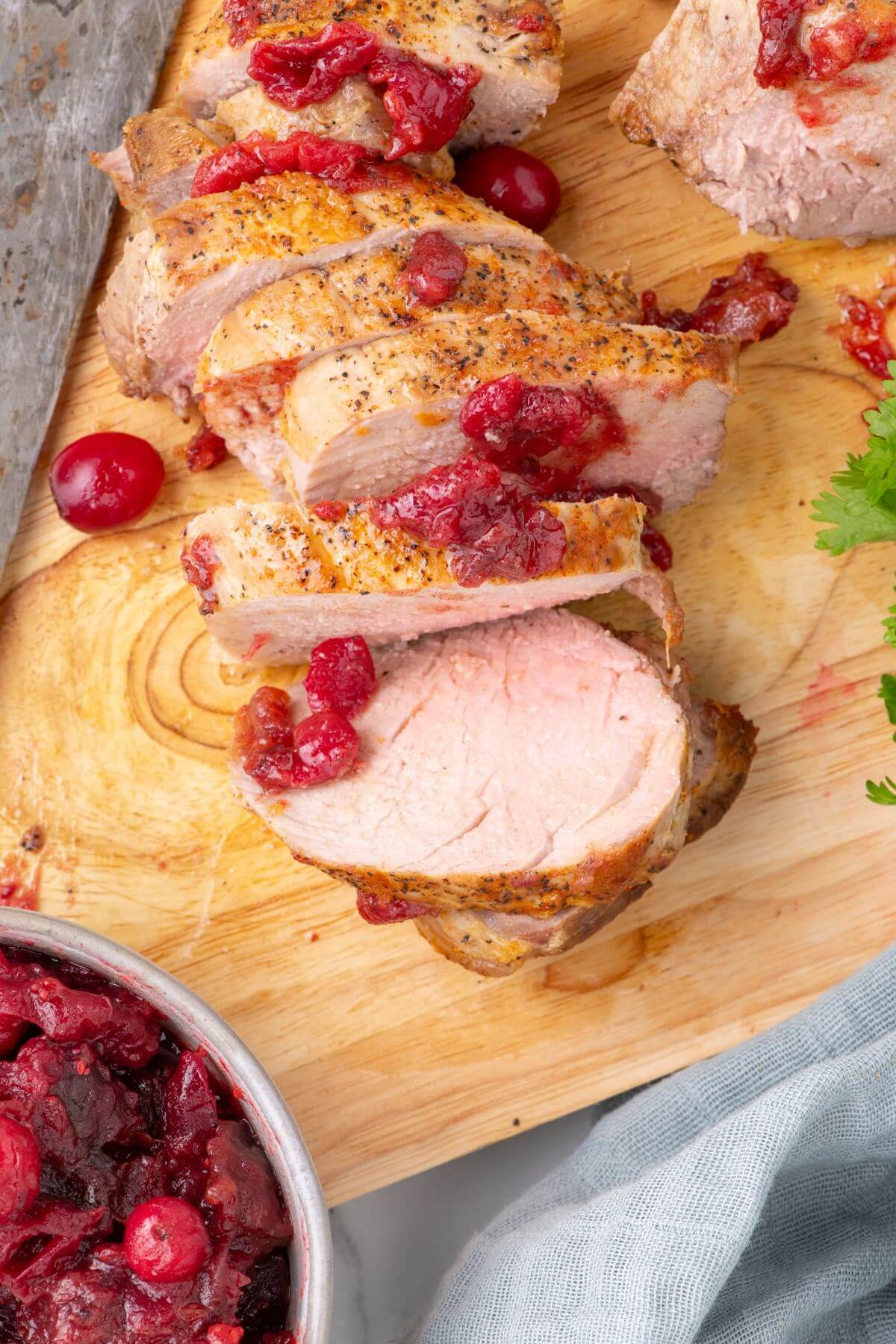 Marinated pork tenderloin in air fryer topped with cranberry chutney.