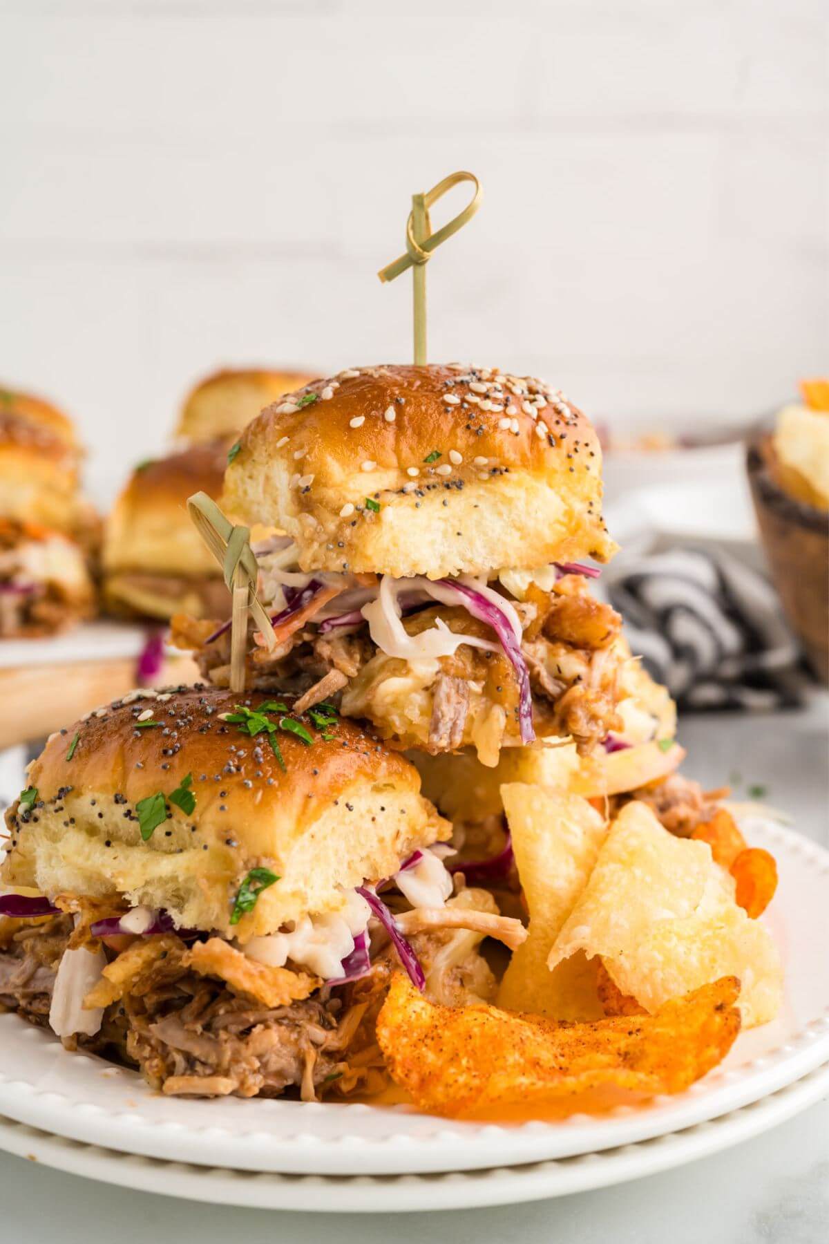 pulled pork sliders recipe stacked on each other on a plate.