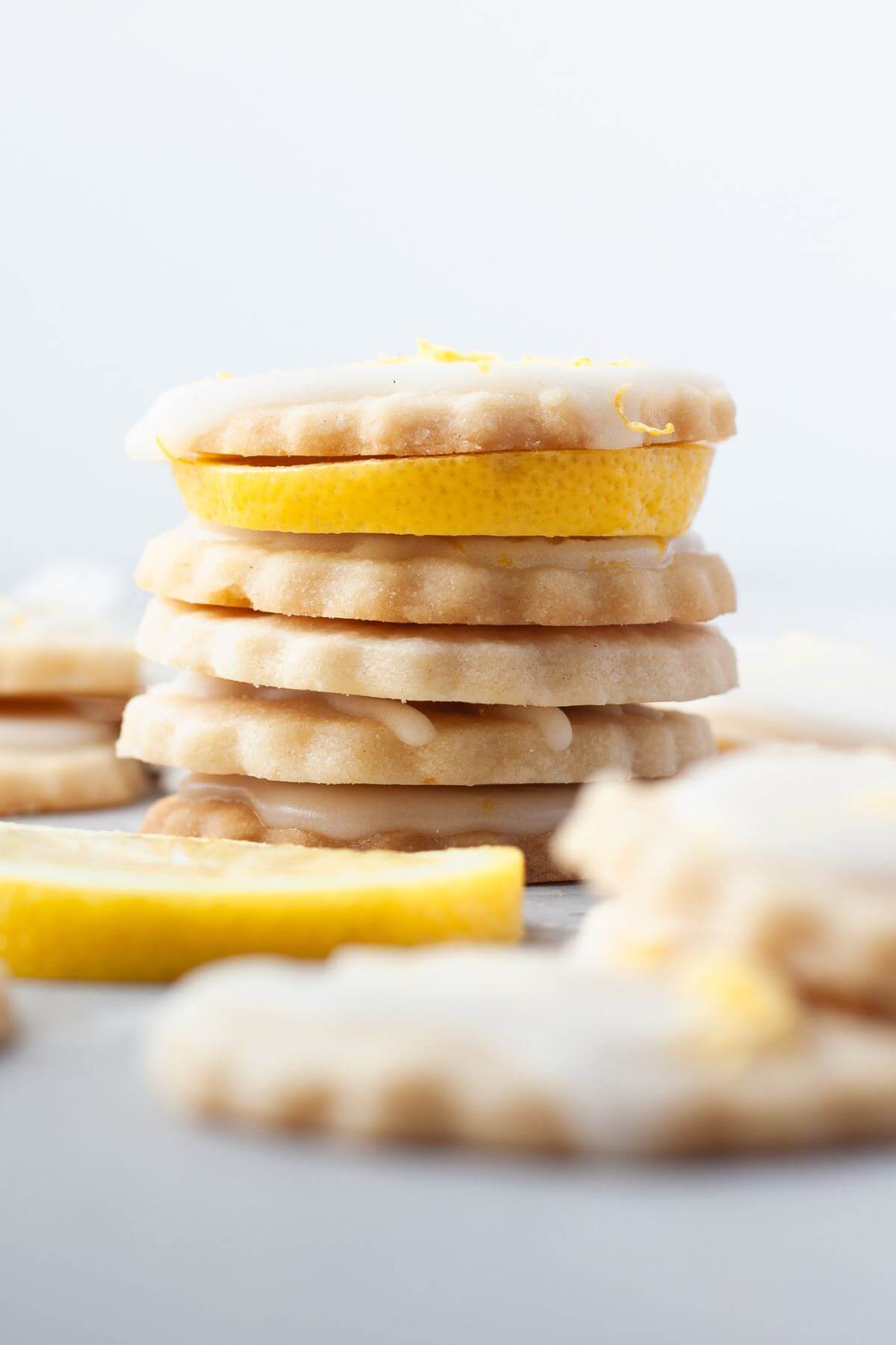 A stack of cookies has lemon slices between them.