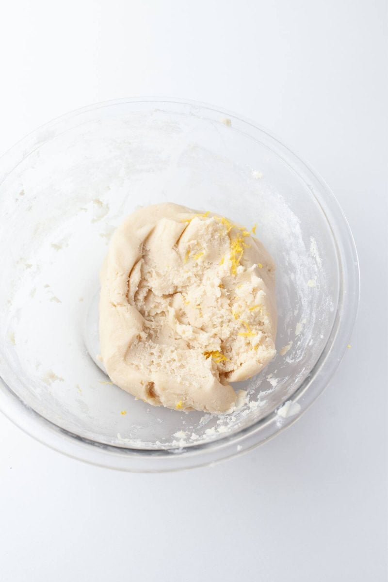 A rough cookie dough ball in mixing bowl.