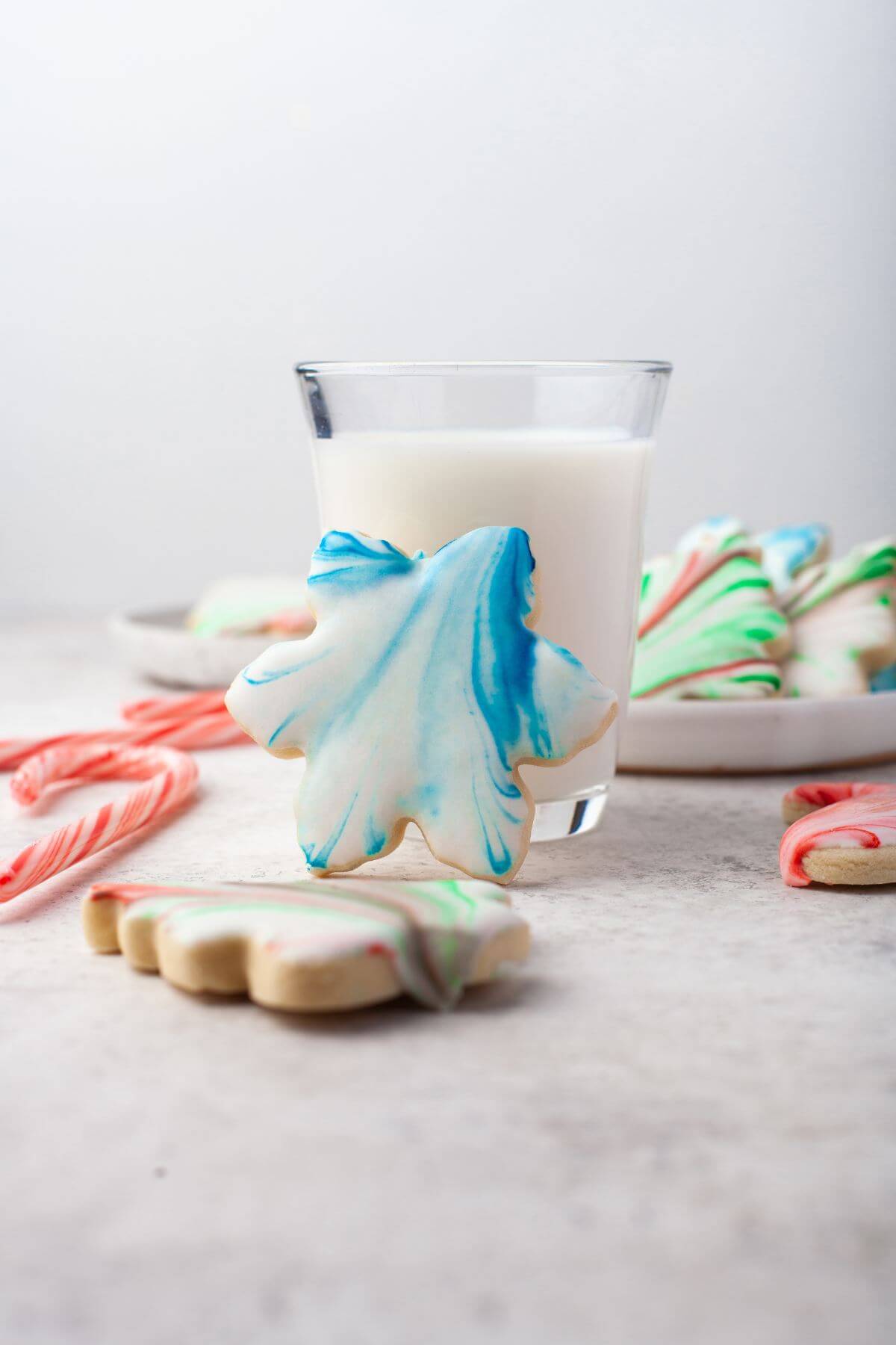 Bright blue leaf shaped cookie props on milk glass.