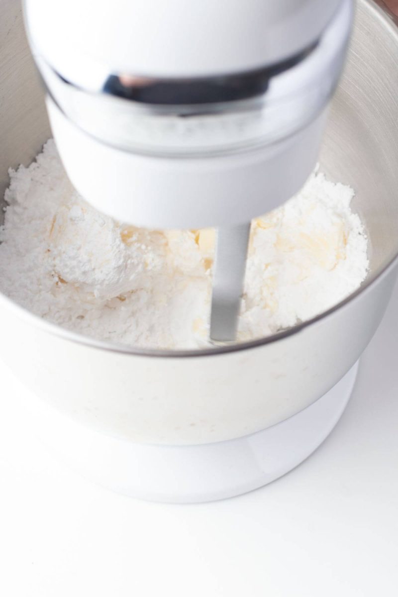 Stand mixer with powdered sugar shown.