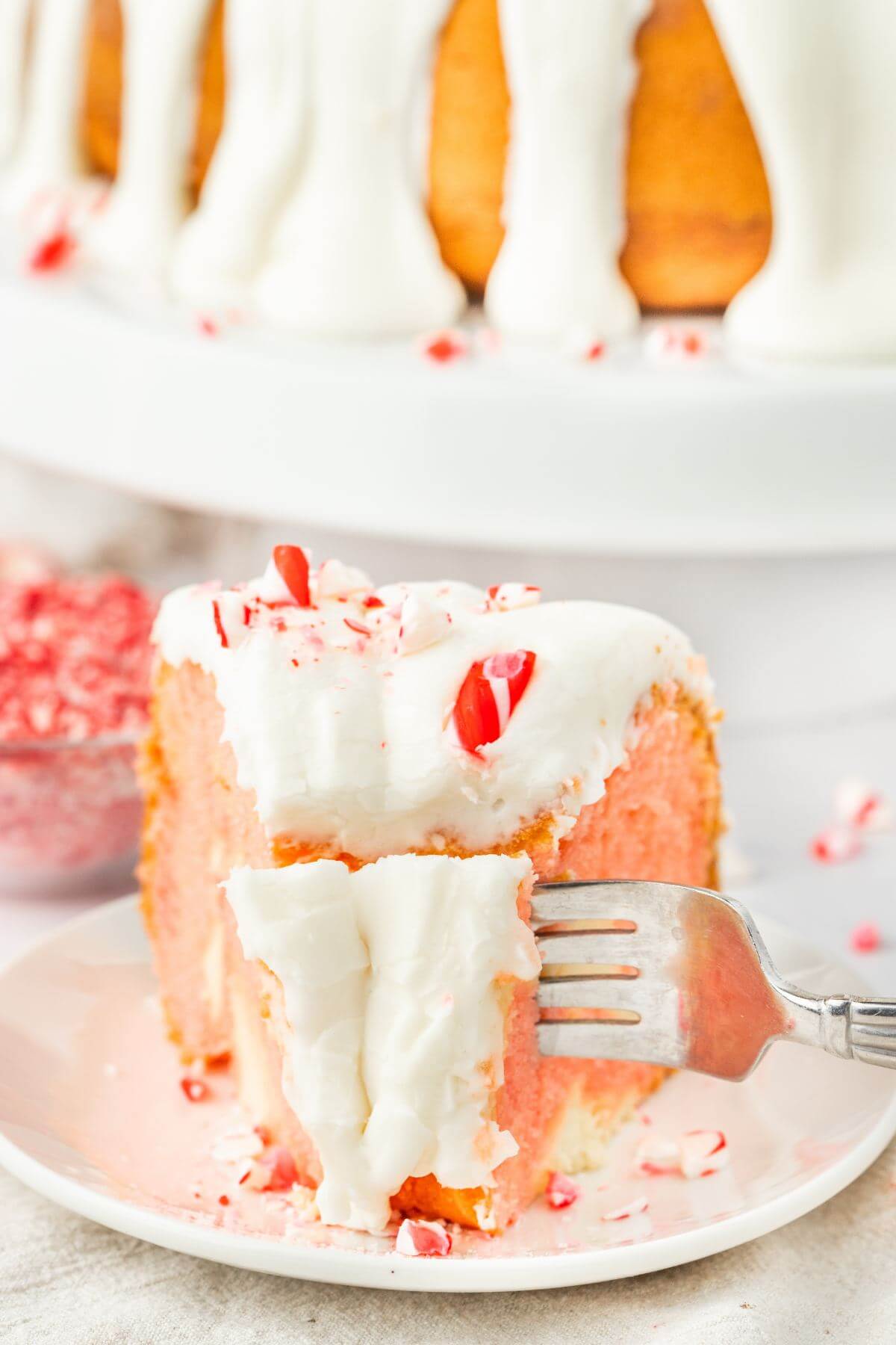 A fork digs into a slice of Peppermint Cake.