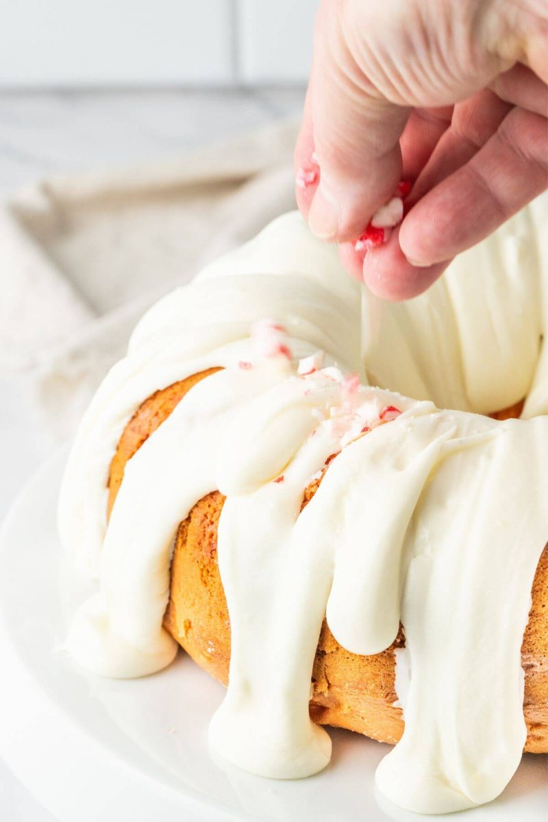 Adding crushed candy canes to Peppermint Candy Cane Bundt Cake Recipe.