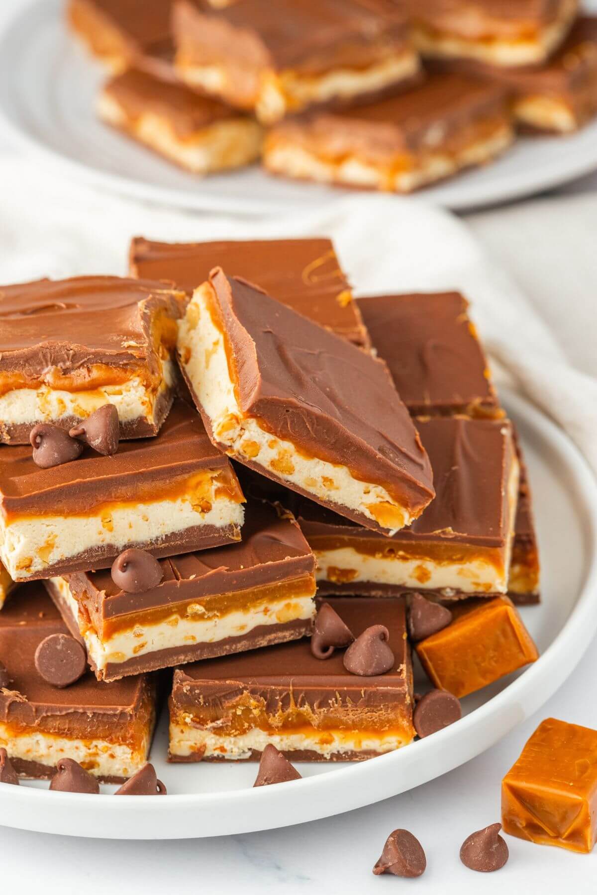 Two plates are full of layers of fudge bars.