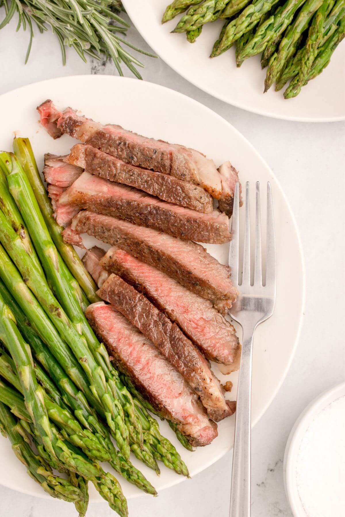 Sous Vide Boneless Ribeye Steak served on plate with side dishes.