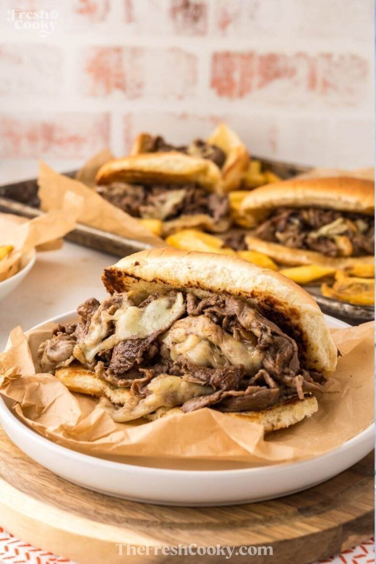 Several Philly cheesesteaks being served to pin.