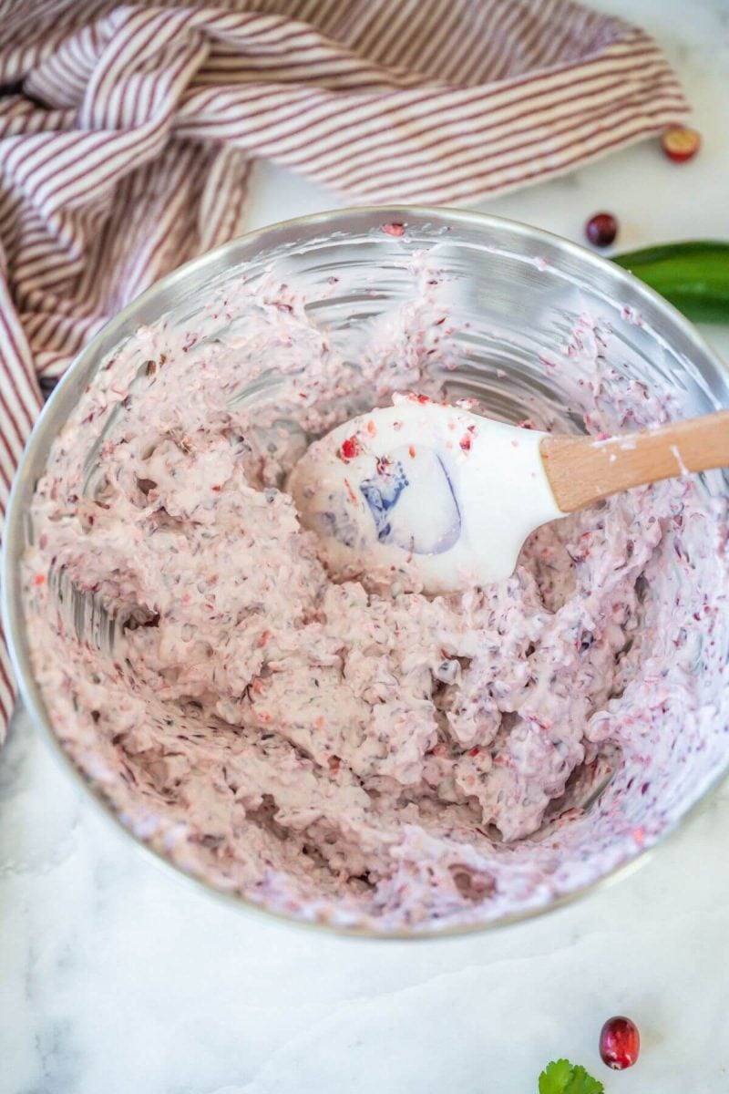 Whipped cranberry jalapeno relish and cream cheese in mixing bowl. 