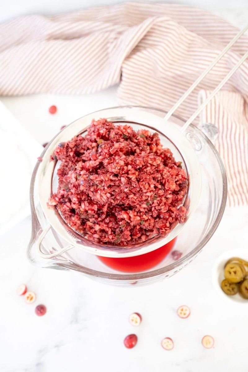 Straining the cranberry relish of excess juices. 