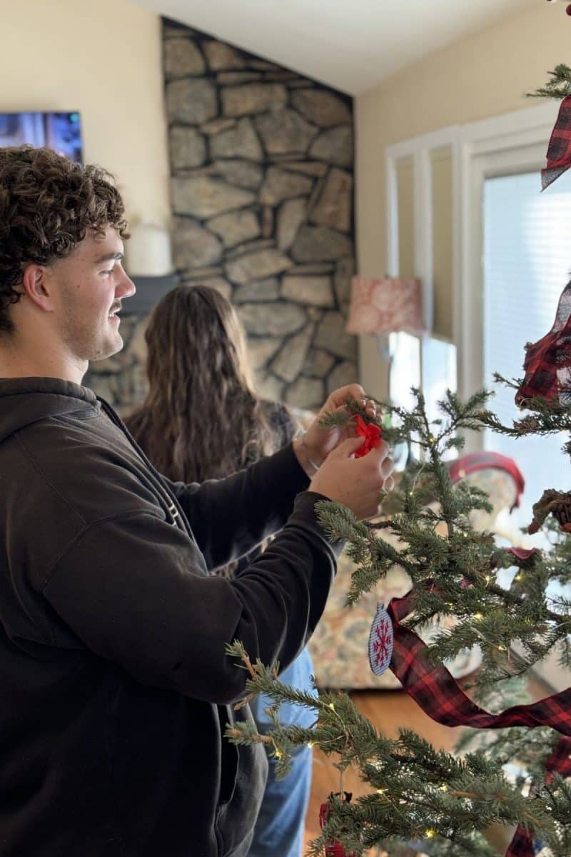 Kieran hanging ornaments on the Christmas tree. 