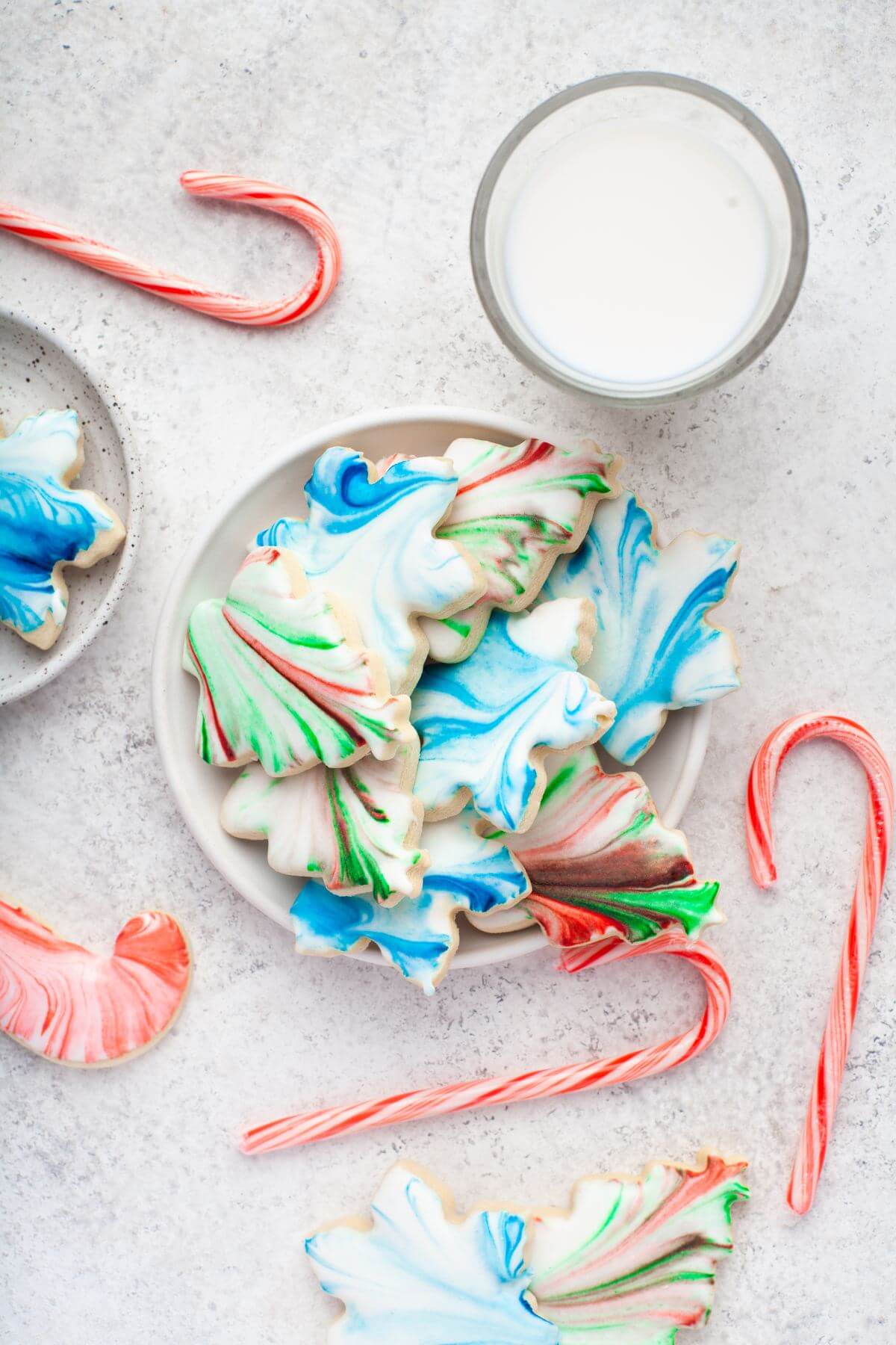 Top view shows full plate of bright marbled cookies.