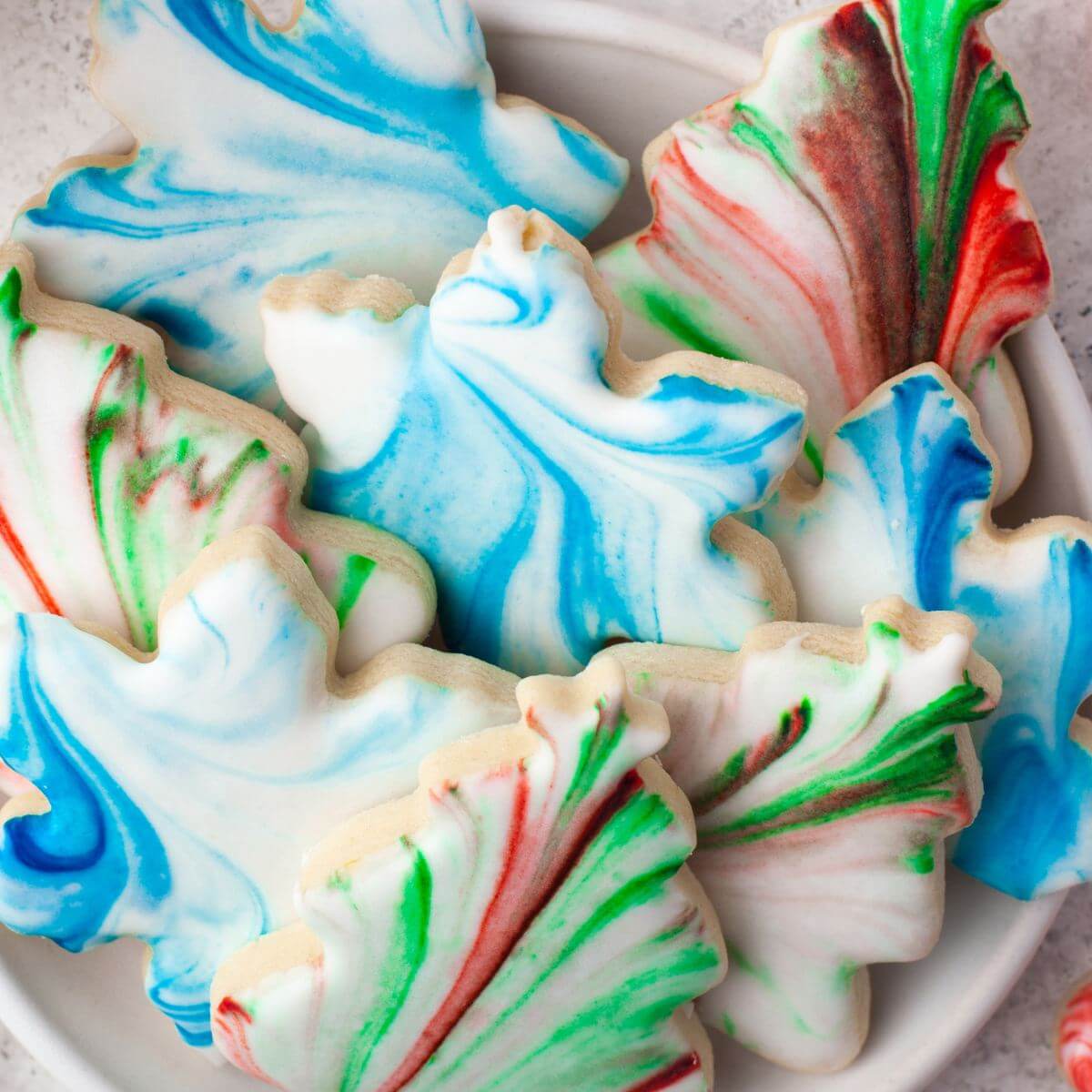 Seven various marbled cookies are shown close up.