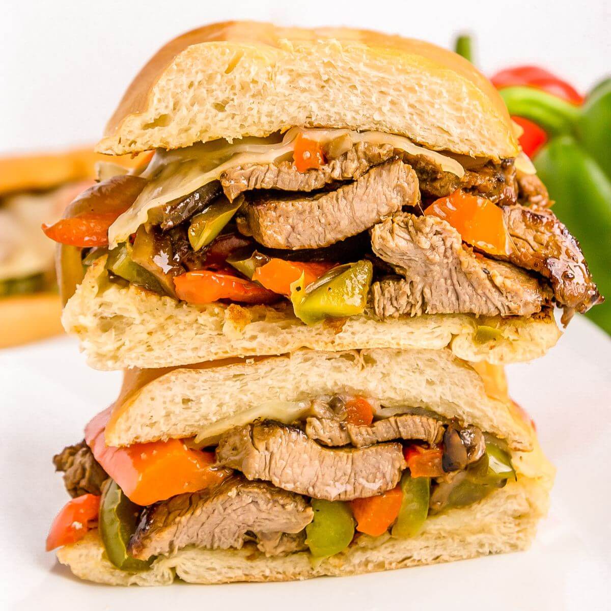 Sandwich halves are stacked on top of each other showing side views of the inside filling.