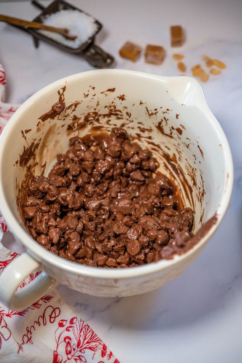 A mixing bowl holds partly melted chocolate chips.