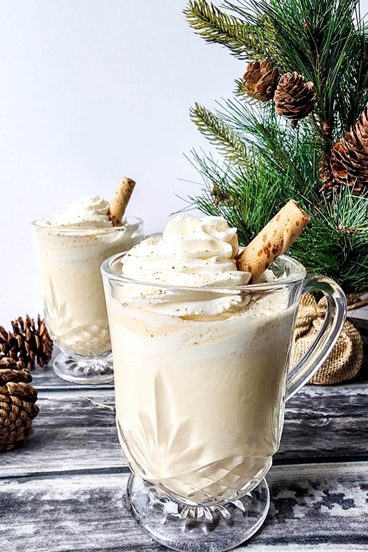 Eggnog milkshakes are shown topped with whipped cream and cookie straws.