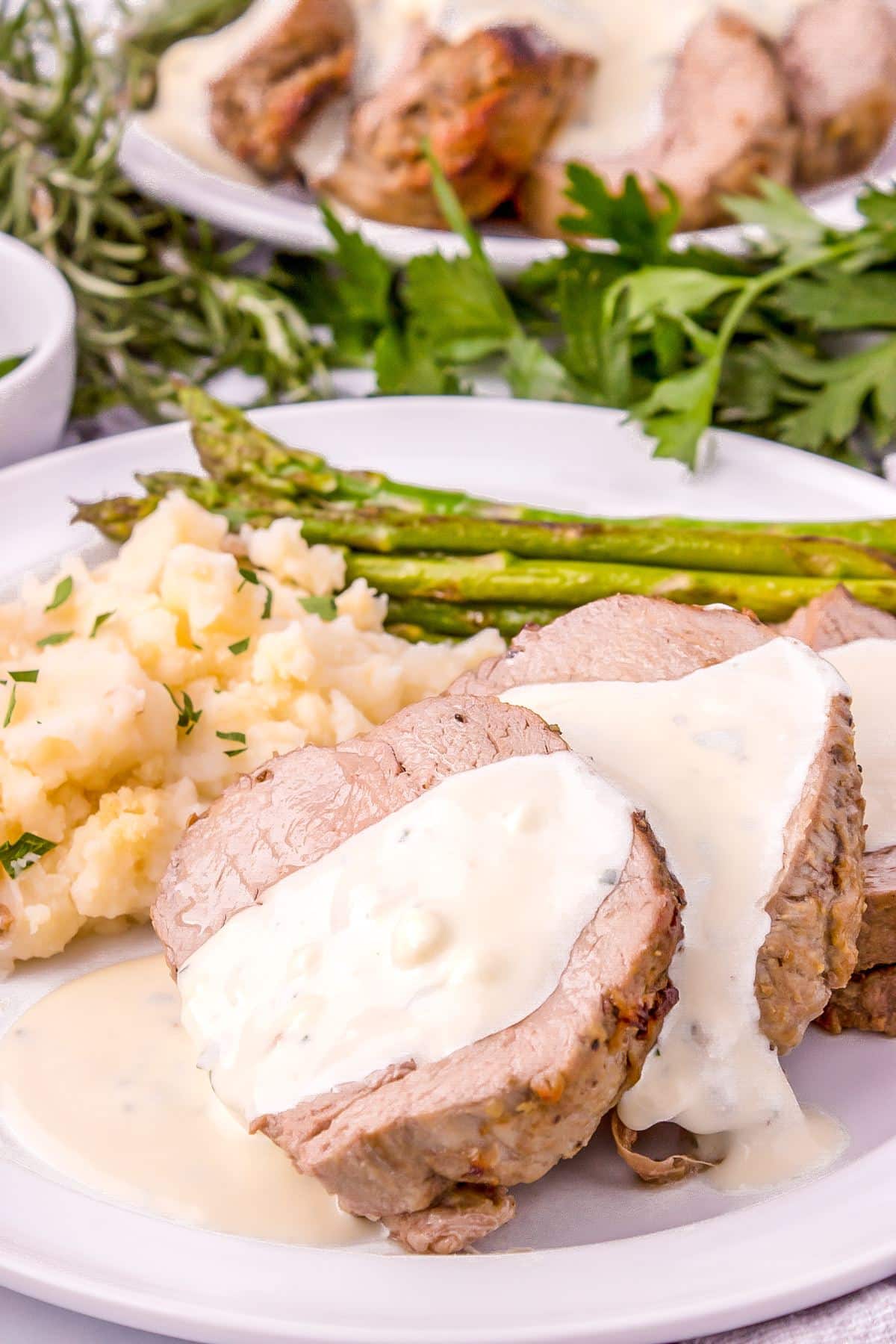 Beef tenderloin slices drizzled with Gorgonzola sauce, mashed potatoes and asparagus.