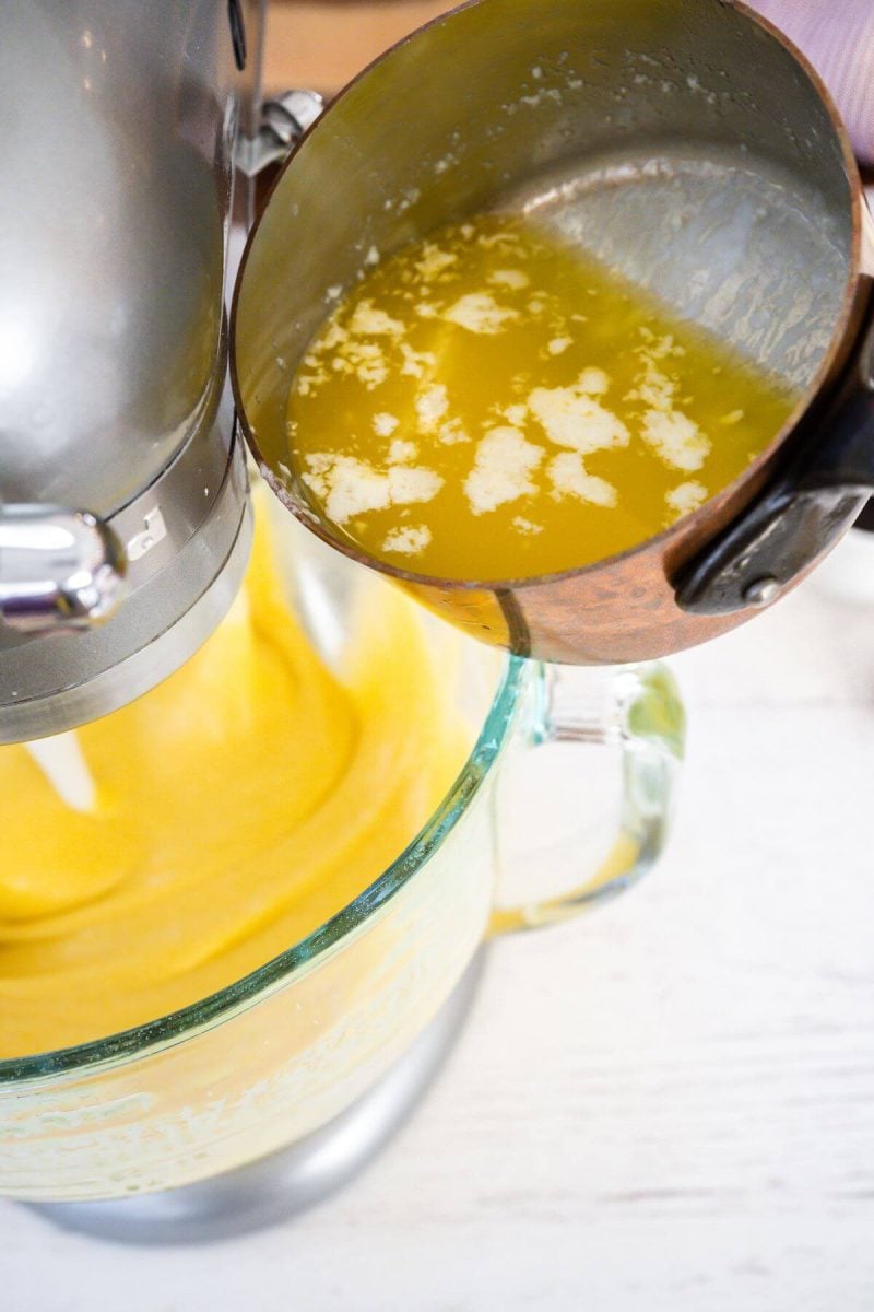 Melted butter is about to pour into mixing bowl batter.