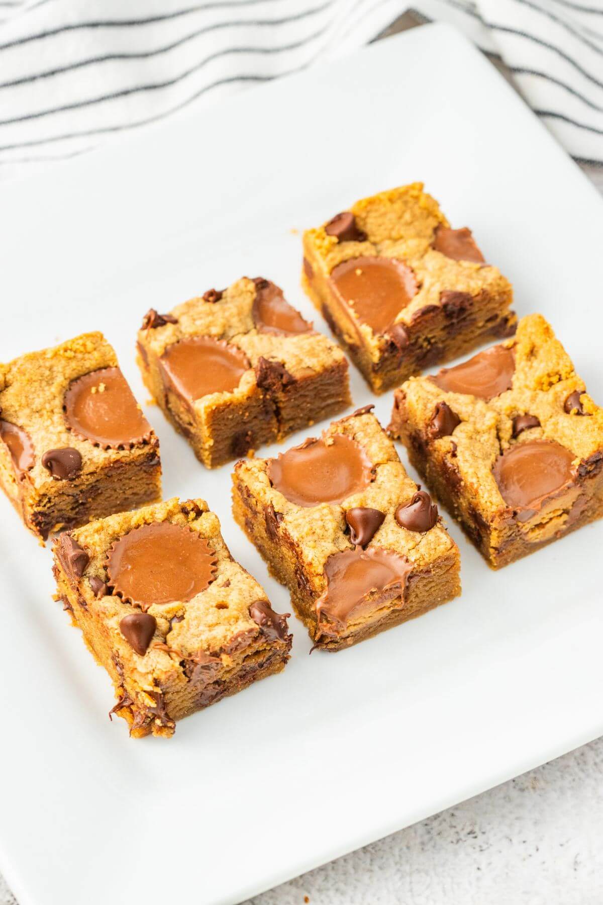 A square plate holds two rows of blondies.