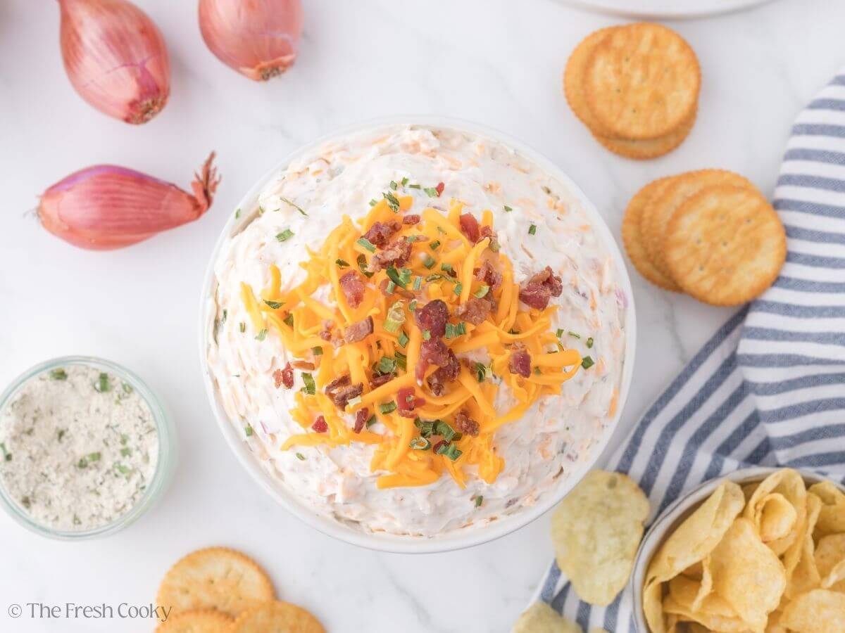 Top down shot of cowboy crack dip with ingredients for dip scattered around.