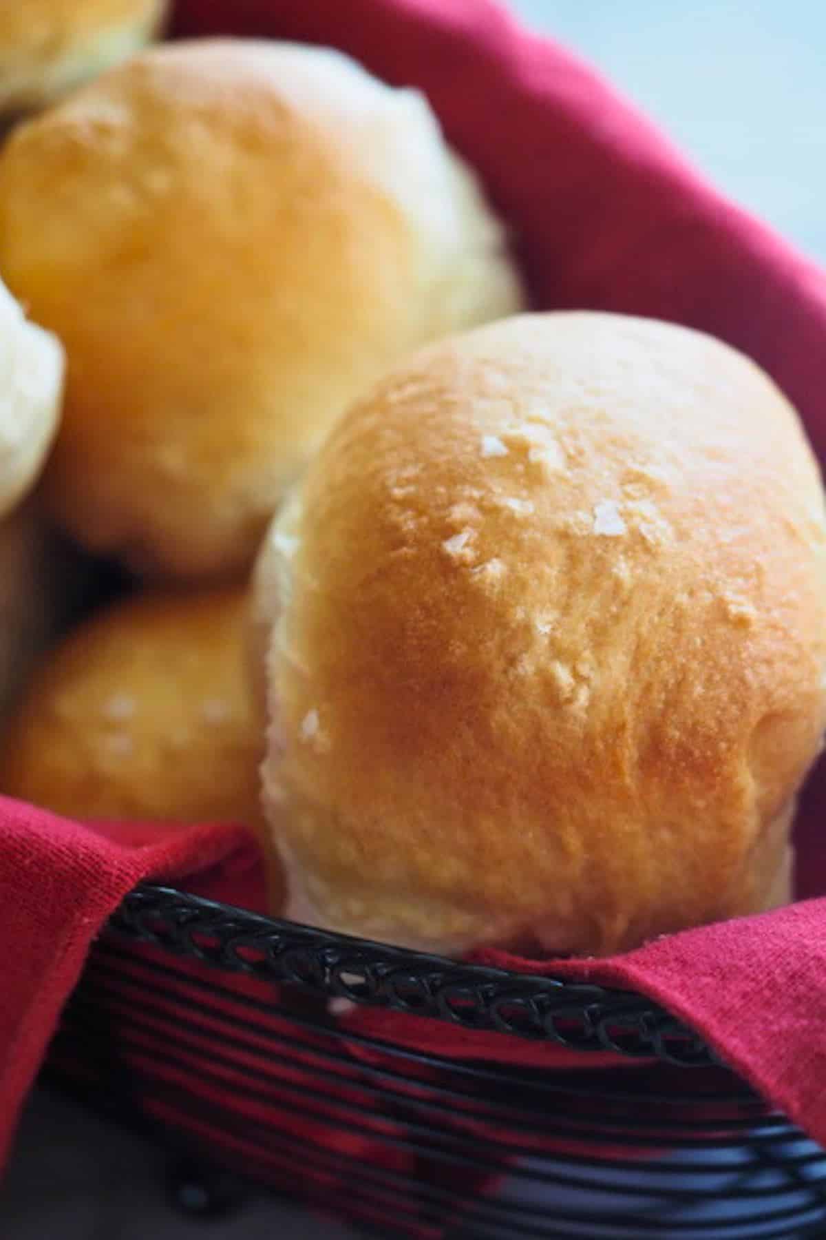 Close up of soft, warm and fluffy yeast roll in basket.