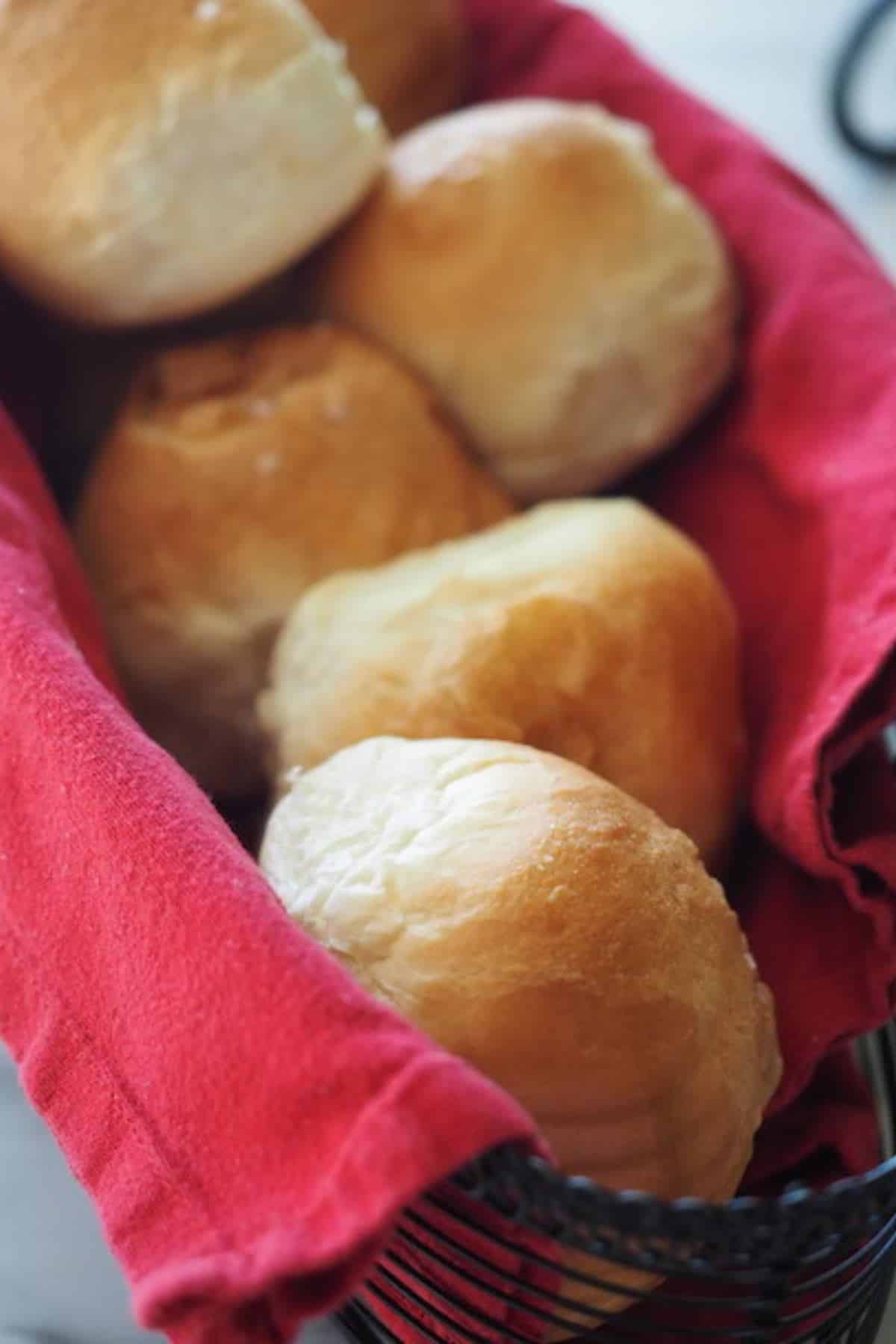 Soft bread machine rolls in a basket. 