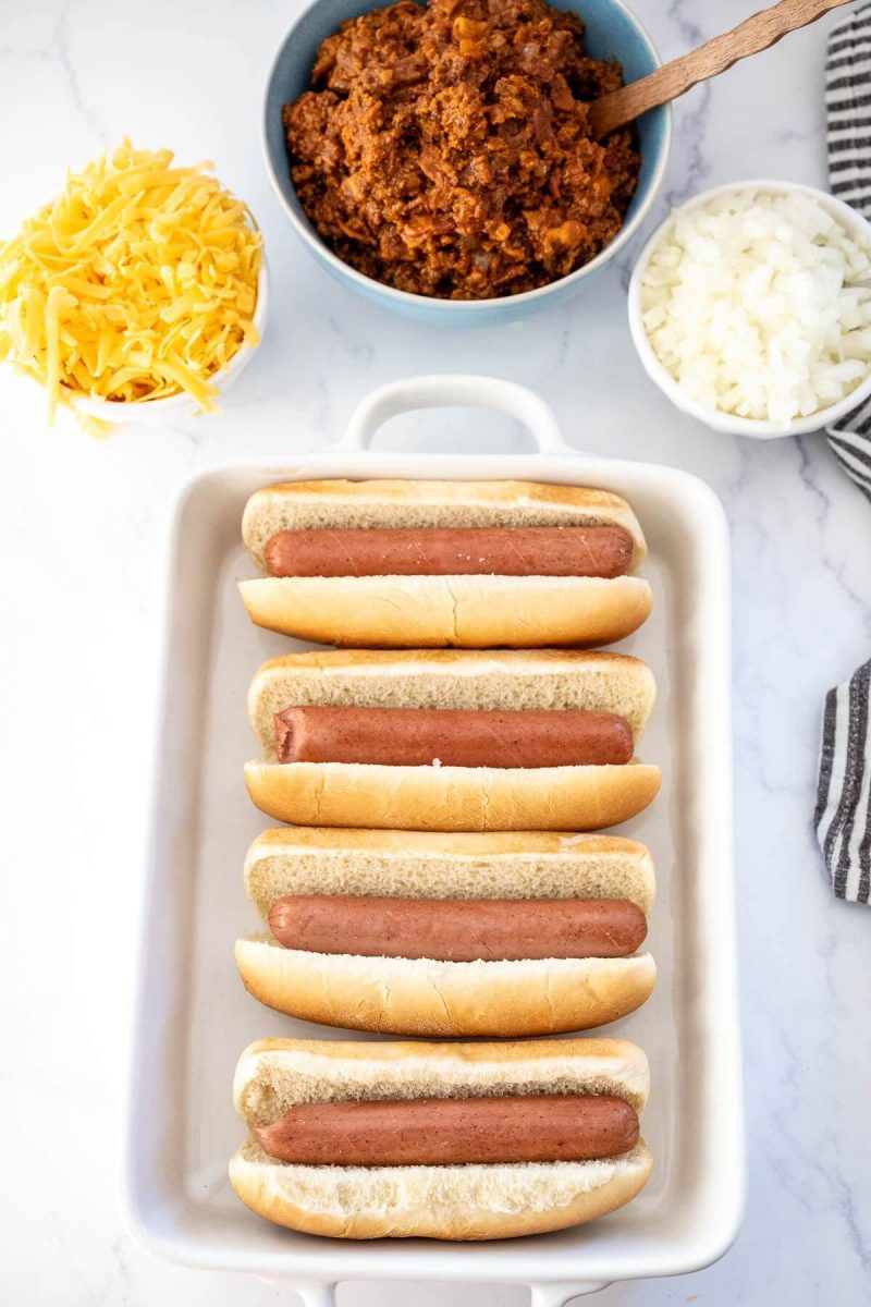 Place hot dog buns and hot dogs in the prepared baking dish. 