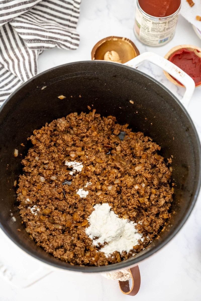 White flour is added to large pot with the ground beef mixture.