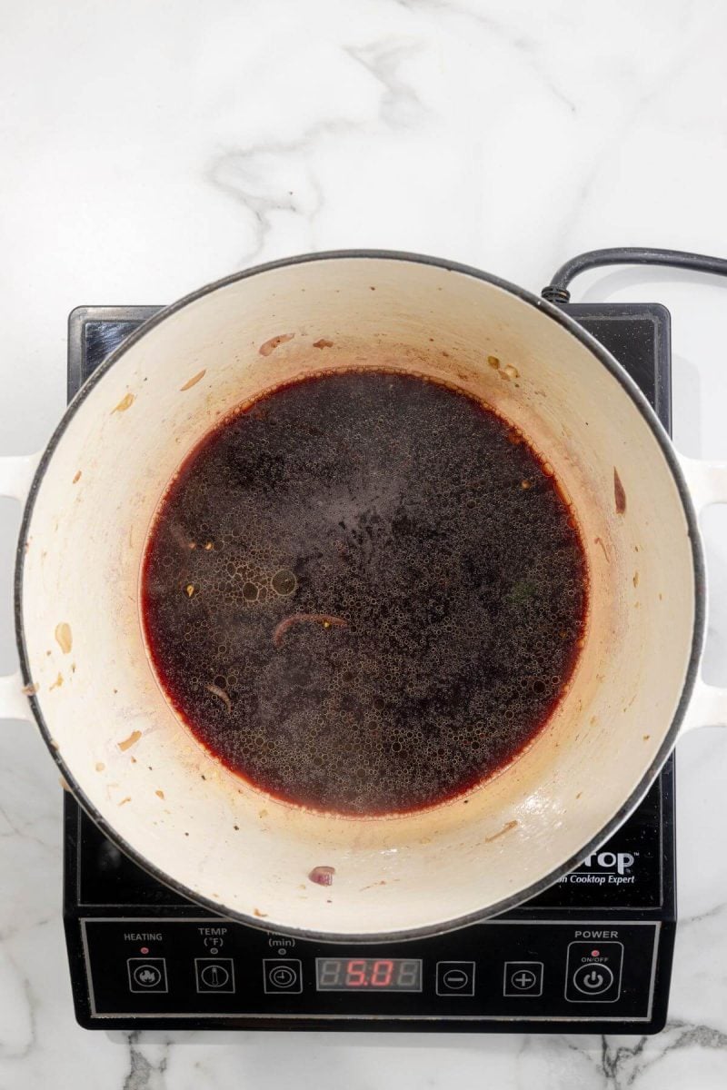 A pan of wine sits on an electric burner.