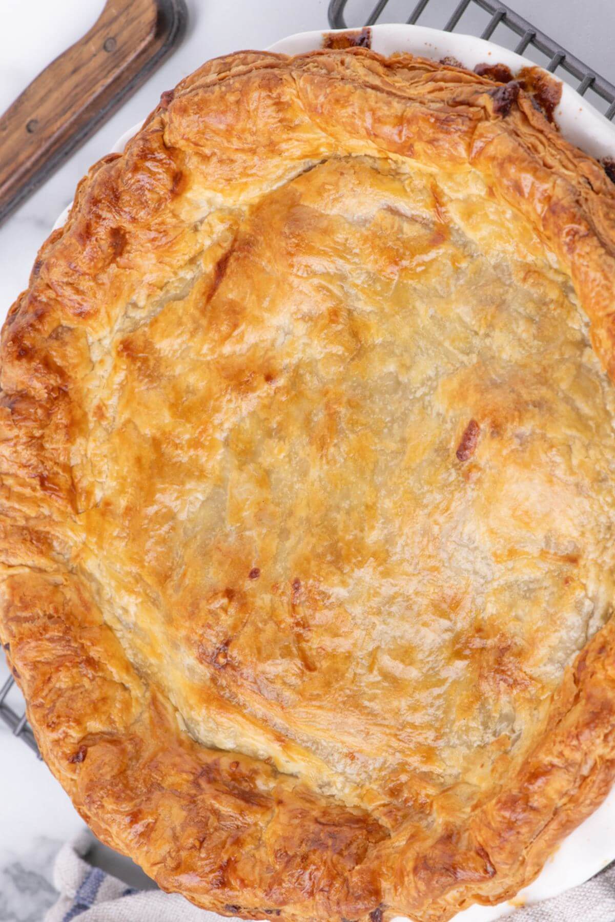 A whole Irish steak pie pie has a beautiful golden flaky crust.