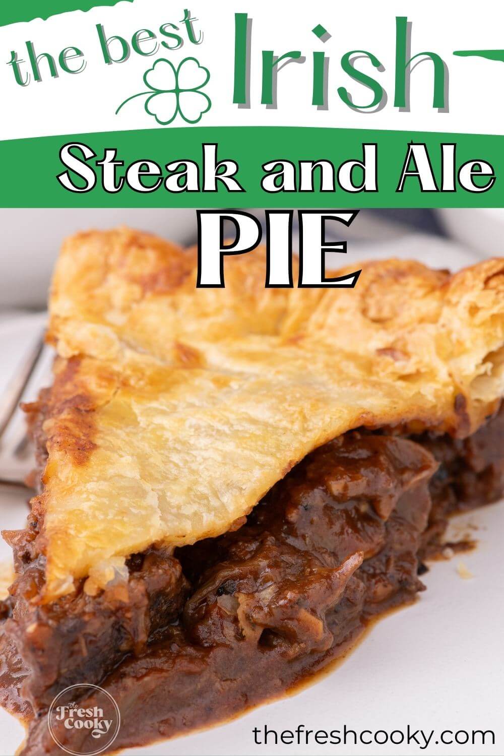 A thick slice of steak and ale pie shows hearty steak filling to pin.