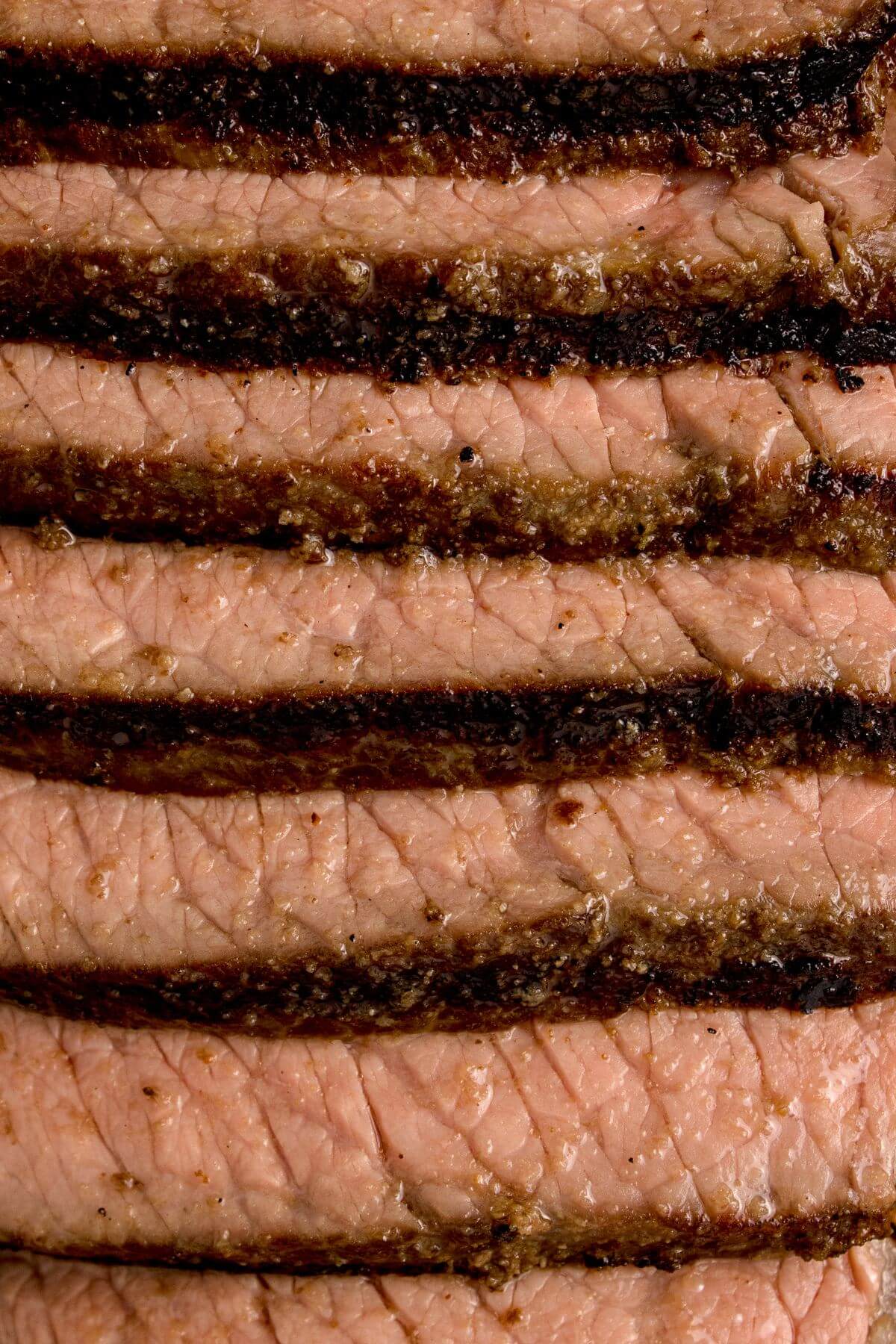 Sliced steak overlaps each other in a row.