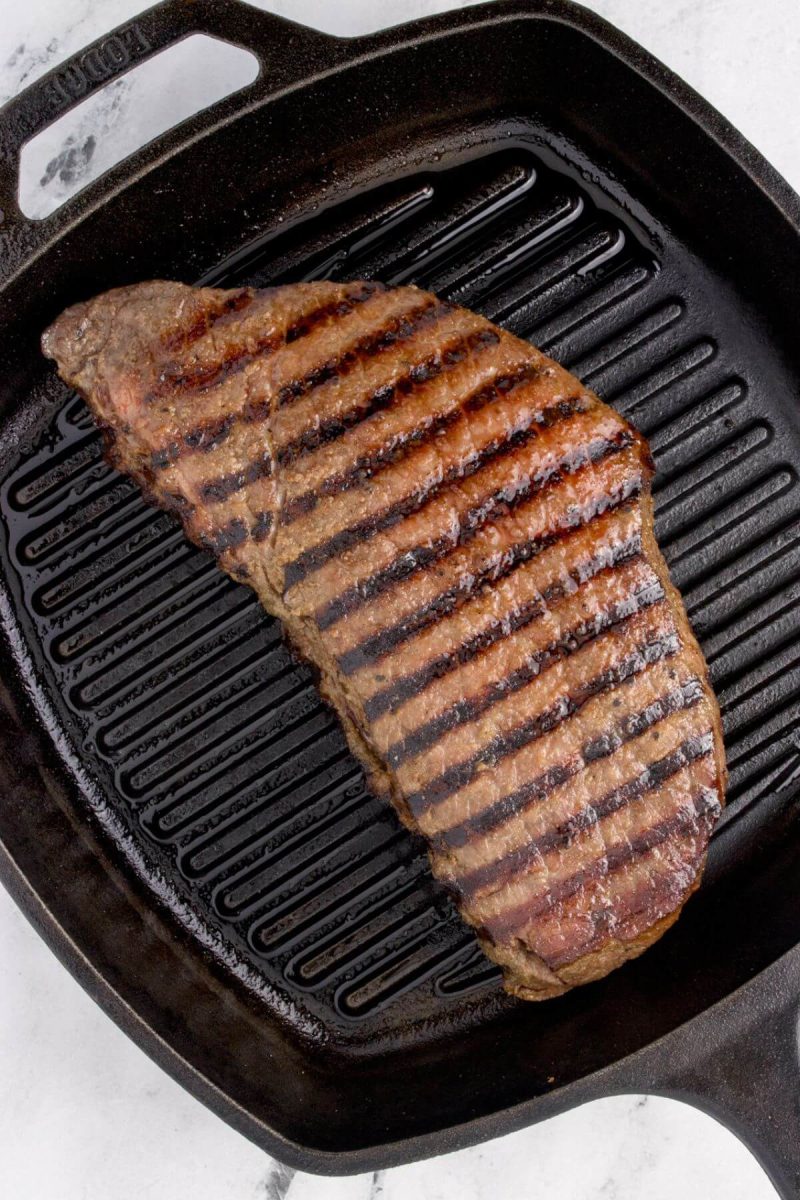 The steak is on a grill.