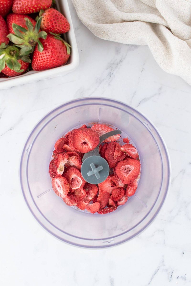 Strawberries are in a food chopper.