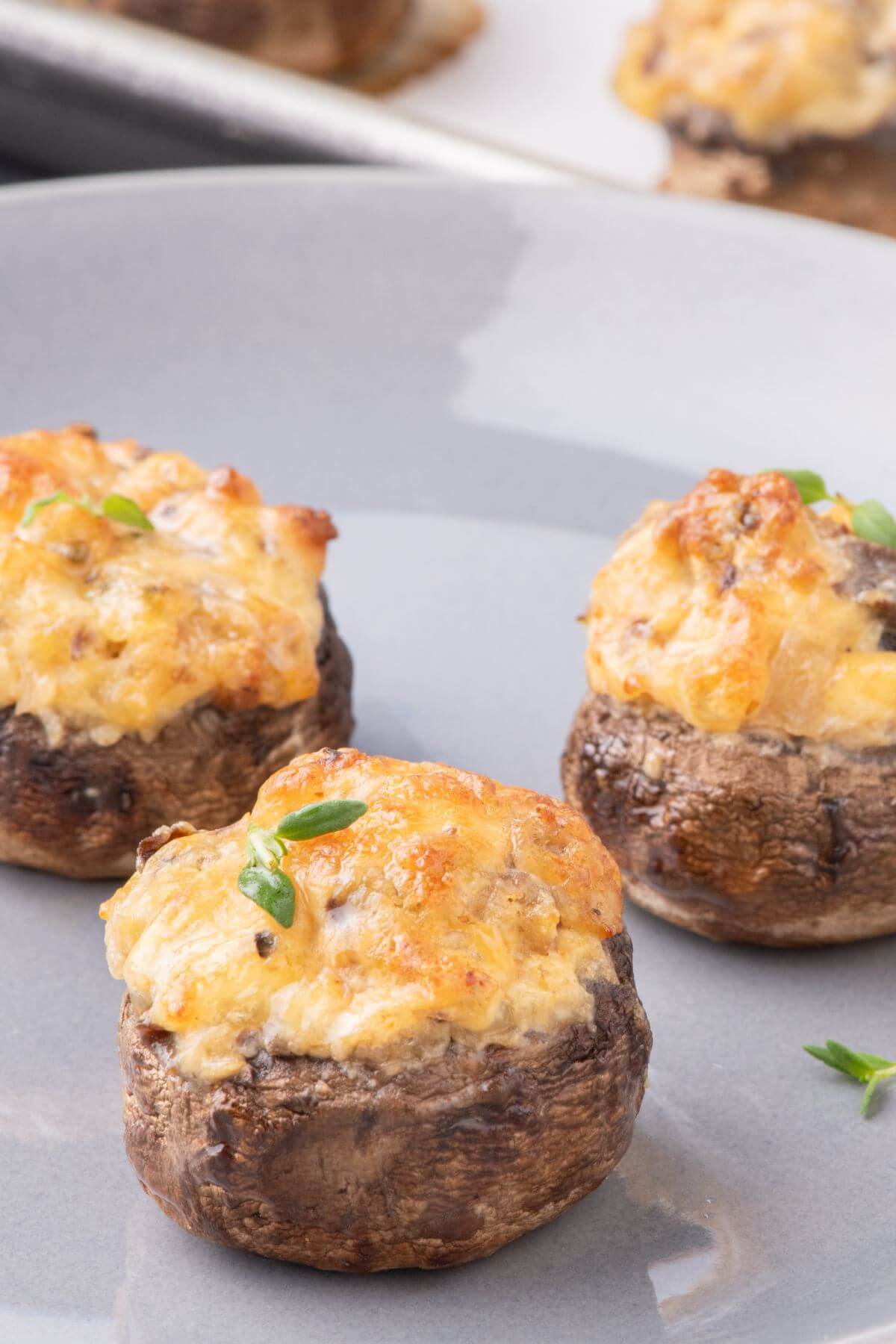 Stuffed mushrooms are topped with gooey cheese.