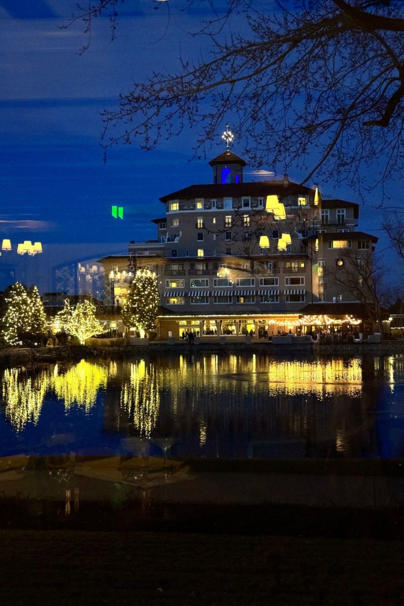 The main building at The Broadmoor lit up at night. 