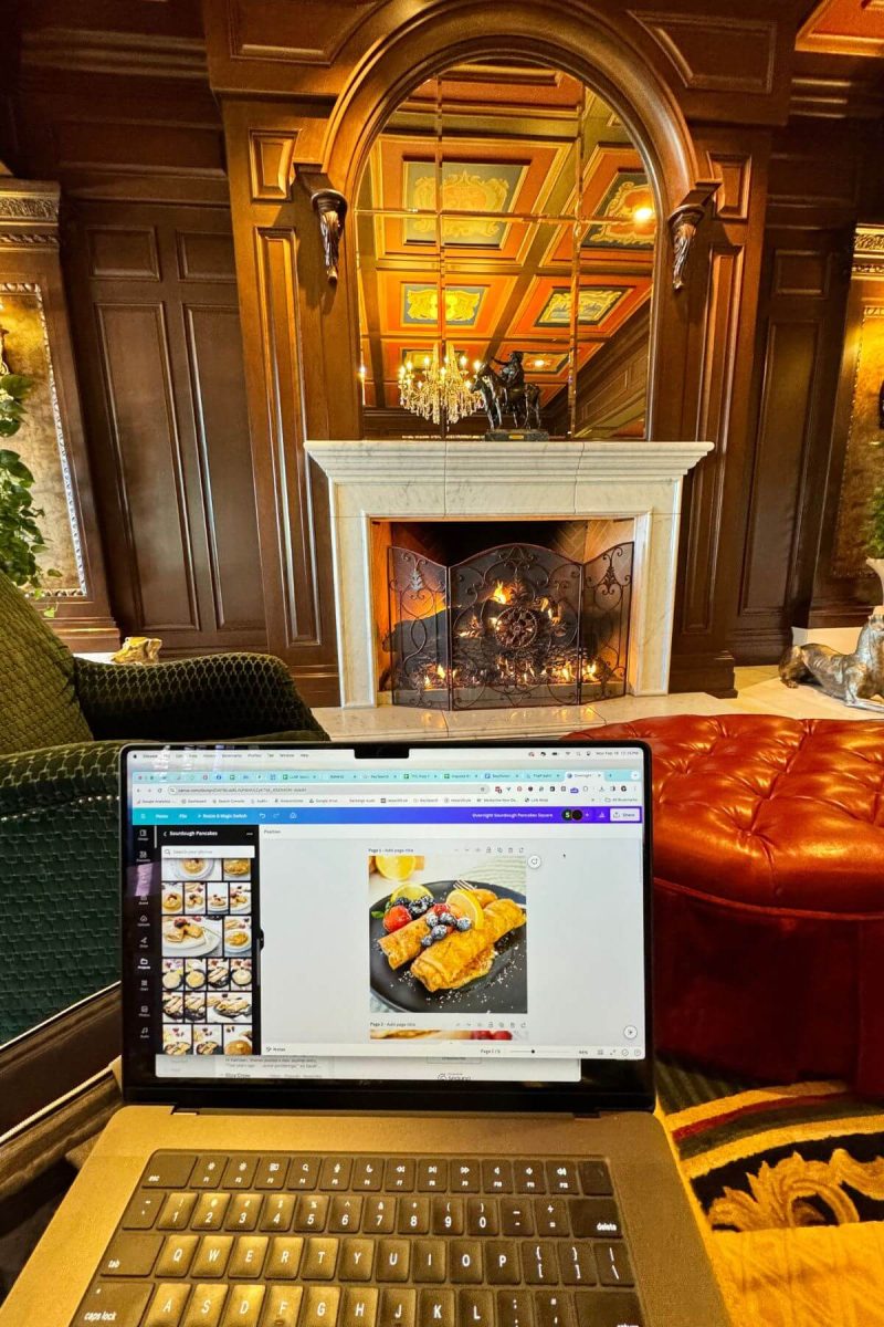 Laptop in front of roaring fireplace. 