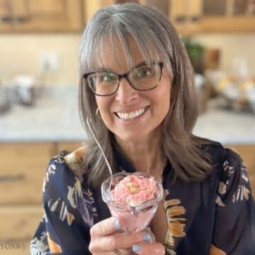 Kathleen, the fresh cooky holding an ice cream glass filled with strawberry shortcake ice cream.