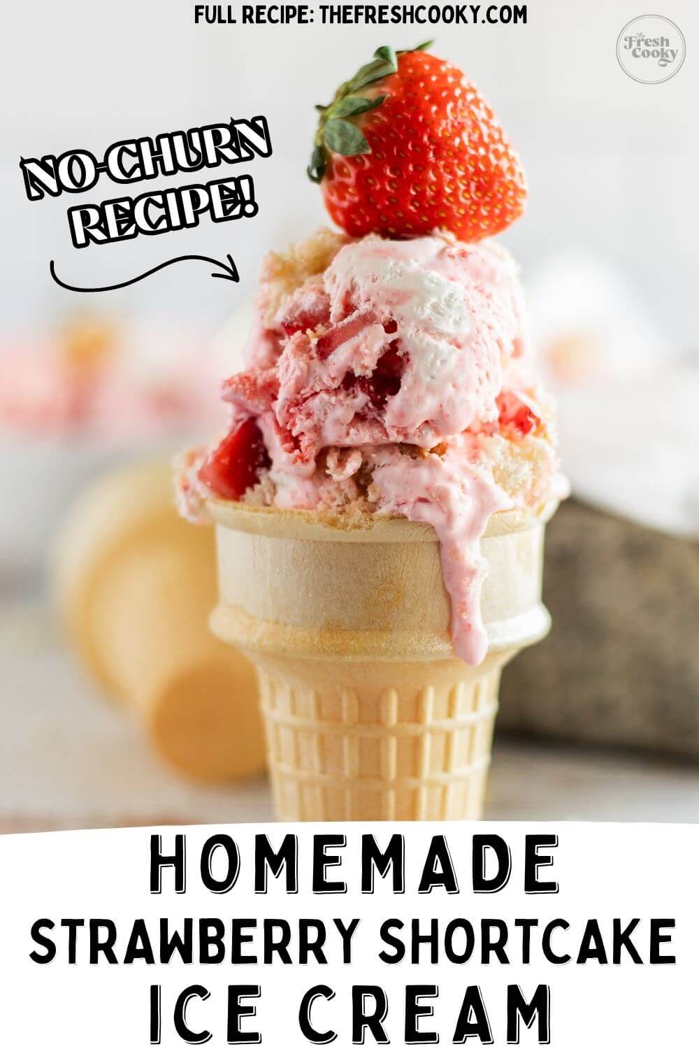 Pink strawberry shortcake ice cream scoops in a cone with a whole strawberry on top, to pin.