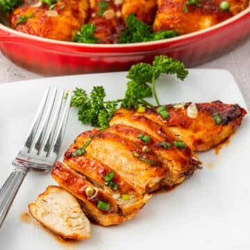 Air Fryer barbecue chicken breast sliced on a plate with a fork.