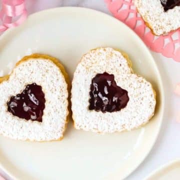 Linzer heart cookies on a plate.