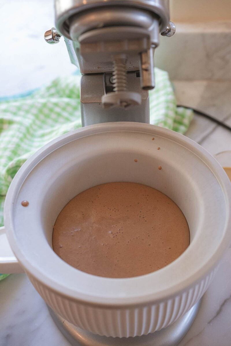 Liquid ice cream base sits in bowl of ice cream machine.