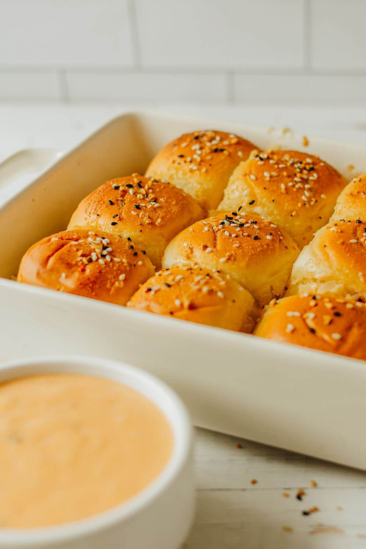 A pan of baked sliders shows Everything but the Bagel seasoning on top.