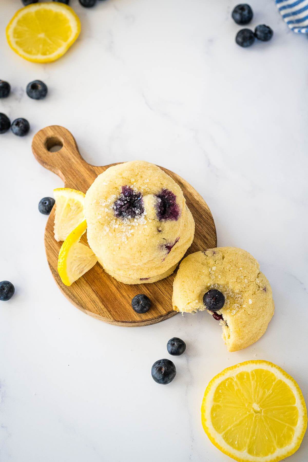 Blueberry Lemon cookies stacked and one with bite taken out of it.