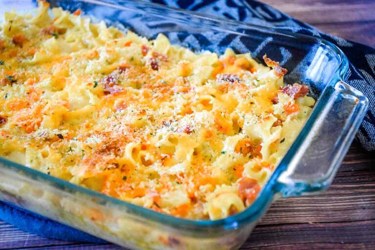 Cheesy ham and noodle casserole in a pyrex casserole dish.