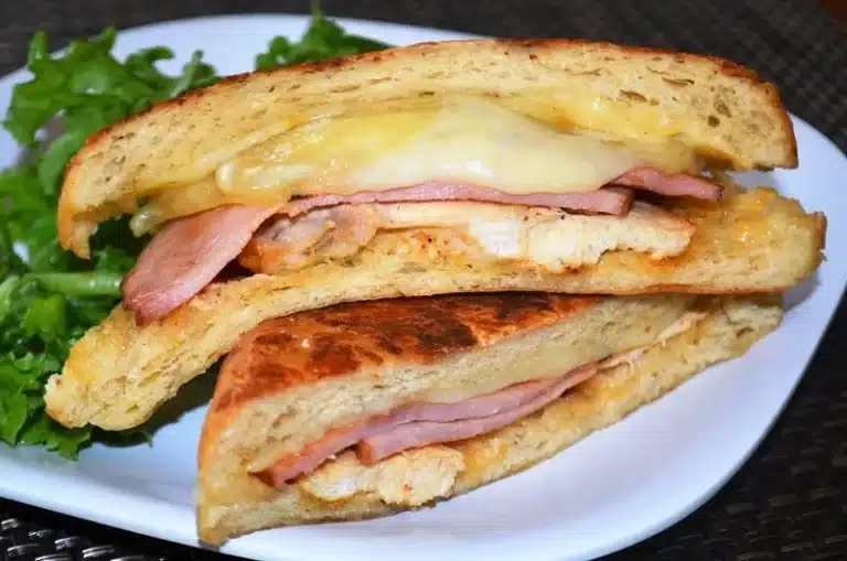 Chicken cordon bleu sandwich sliced in half.