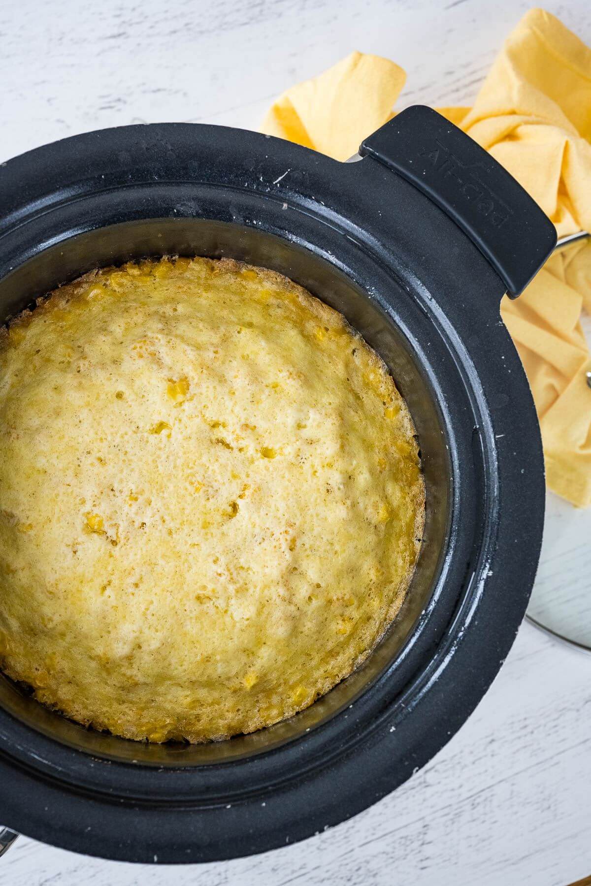 Corn pudding made in crockpot puffed and ready to serve.