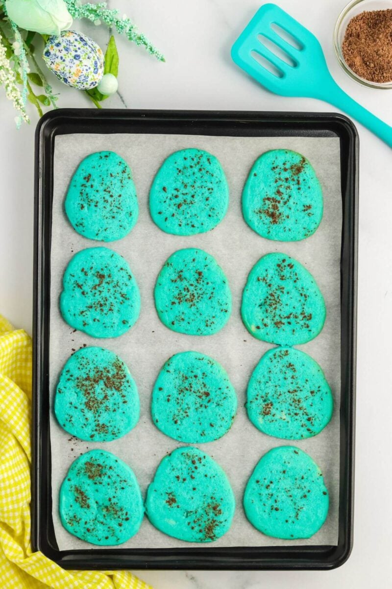 Robins Egg cookies baked on baking sheet with parchment. 