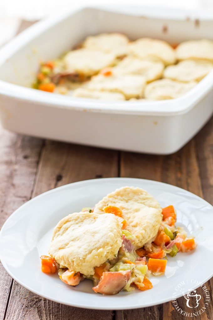 Hot pot pie with biscuits with a serving on a plate.