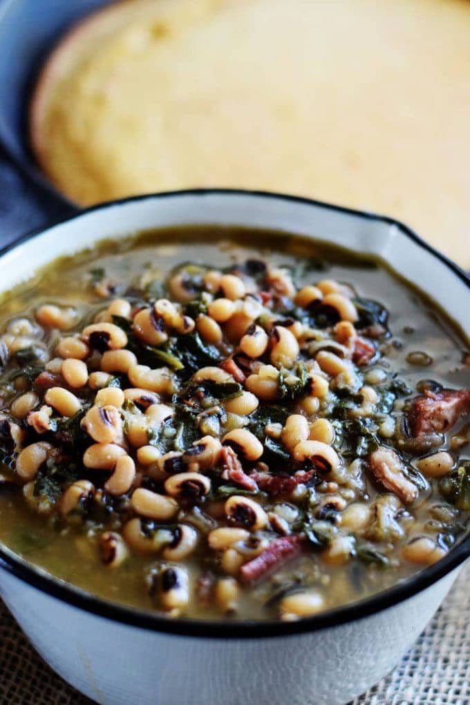 Bowl of Instant Pot blacked eyed pea and collard green soup in a serving bowl.
